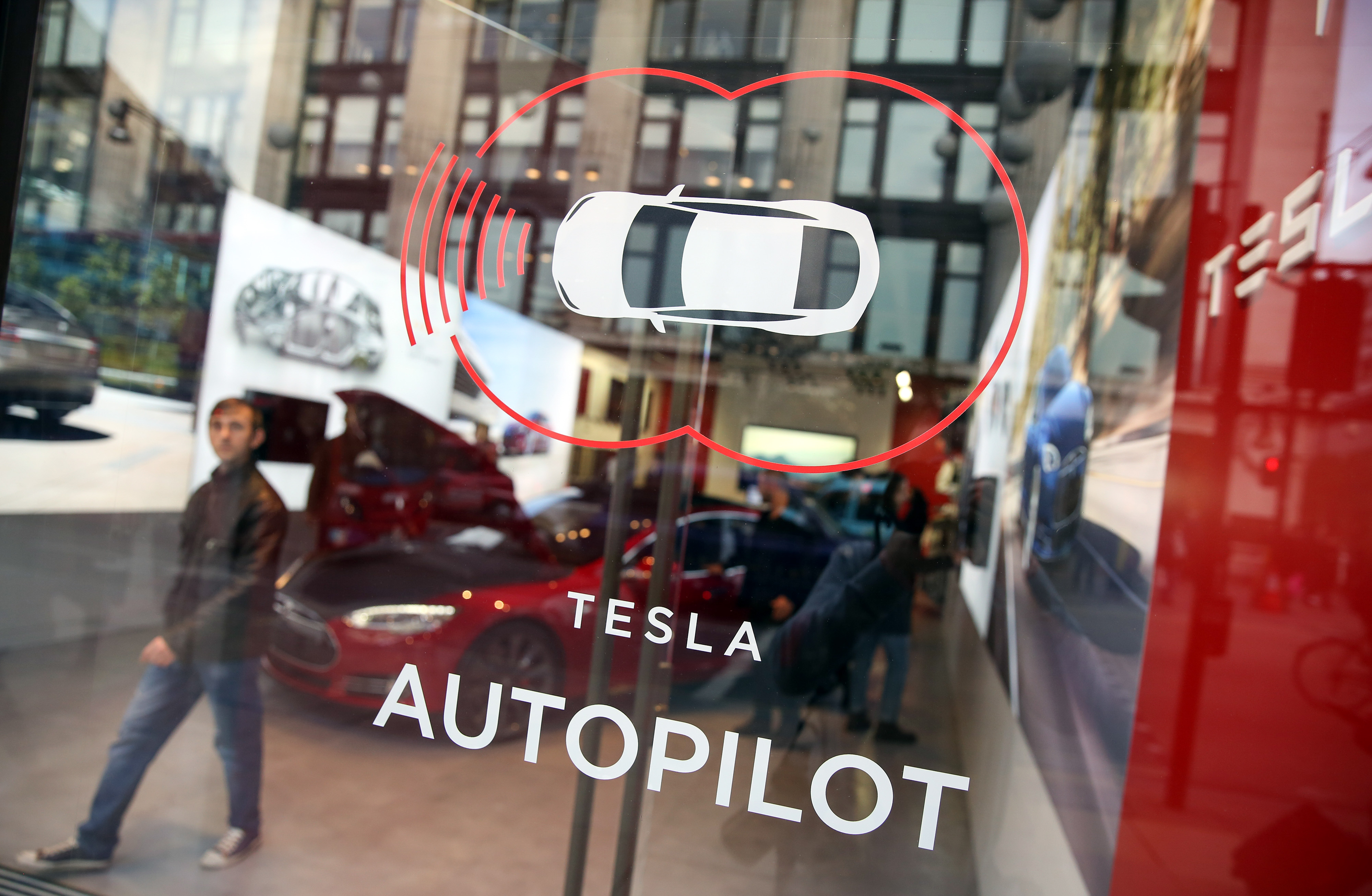 Inside A Tesla Motors Inc. Dealership On Oxford Street As Company Expands In Quest To Become Profitable A decal advertising Tesla Motors Inc.'s Autopilot feature sits on a window of their showroom at a dealership, on Oxford Street in London, U.K., on Wednesday, Dec. 16, 2015. After losing $1.88 billion since 2007, Tesla is piling on the personnel as it offers more models, builds the worlds biggest battery factory and expands globally, including stores opening in Mexico City and Edinburgh.